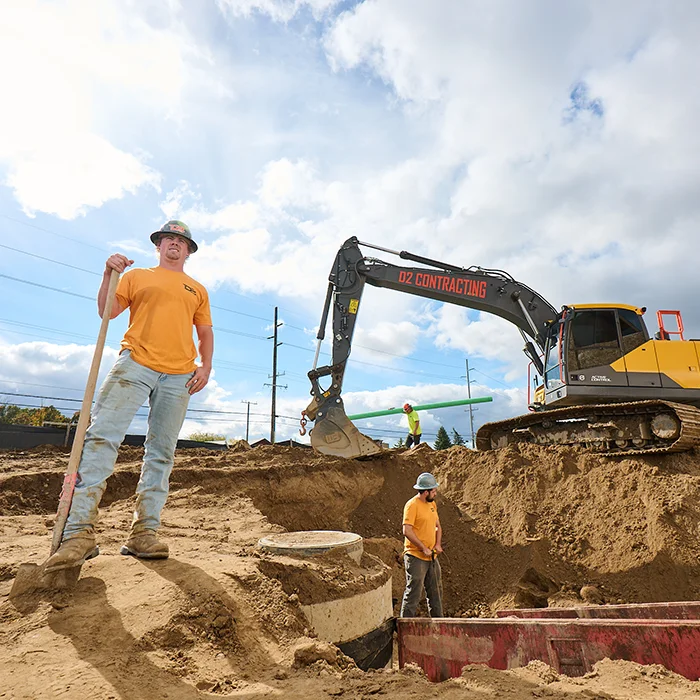 Woman in heavy equipment with the door open talking on a walkie talkie