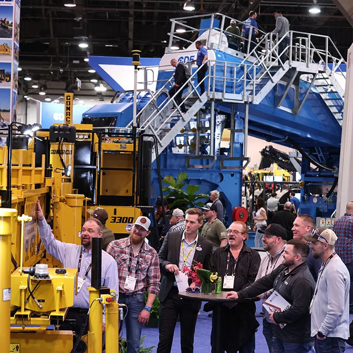 Guy taking picture of truck at CONEXPO-CON/AGG